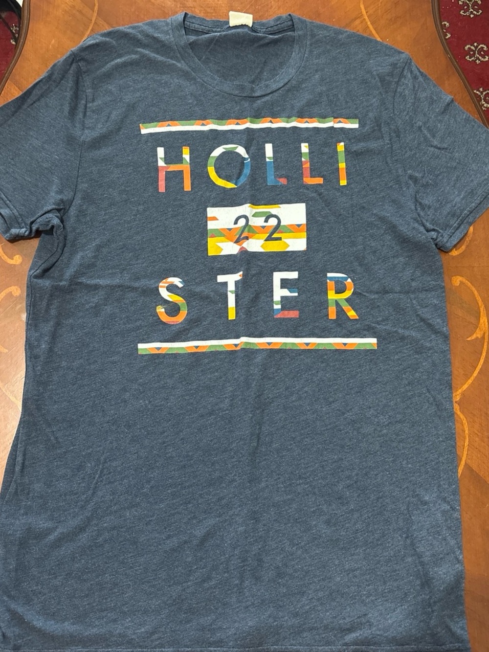 Hollister Heather Navy Short Sleeve Tee with Multicolor Patterned Logo